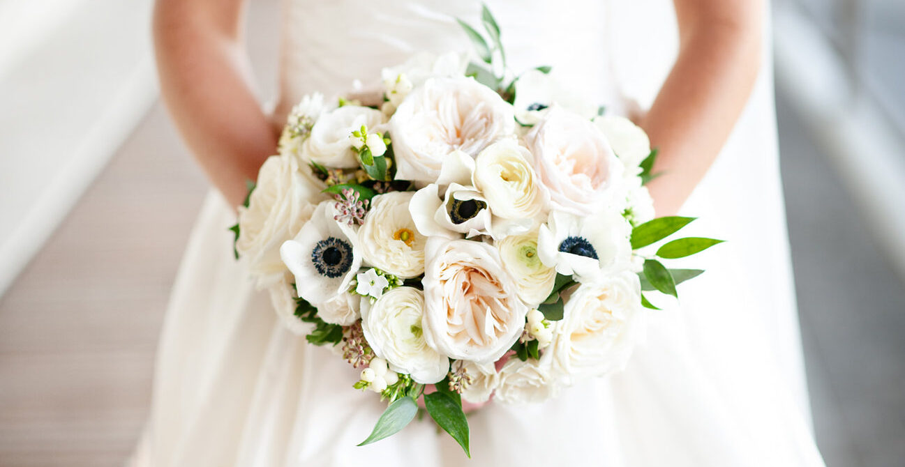 a gril on his wedding holding the flowers